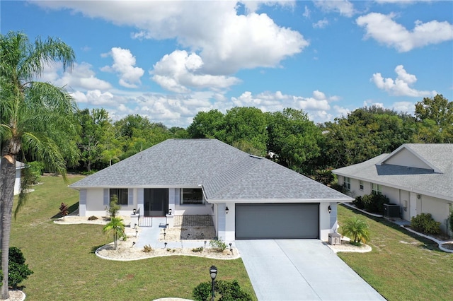 ranch-style house featuring a front yard, central AC unit, and a garage