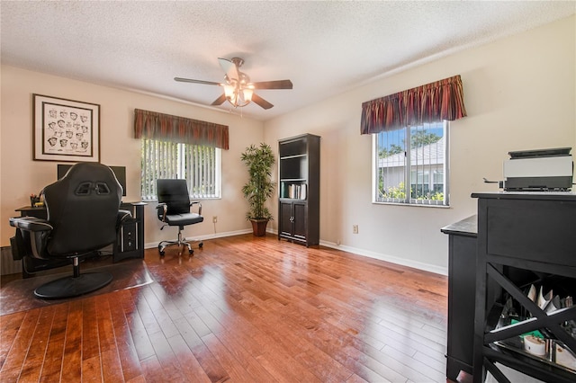 office featuring ceiling fan, hardwood / wood-style flooring, and a textured ceiling