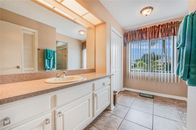 bathroom featuring vanity, a textured ceiling, a shower with curtain, and tile patterned flooring