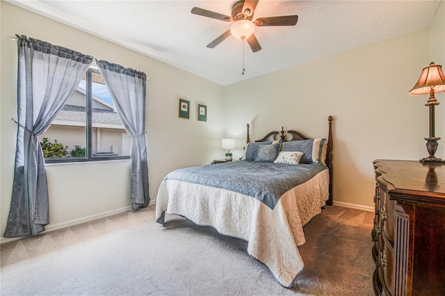 carpeted bedroom with ceiling fan and a textured ceiling