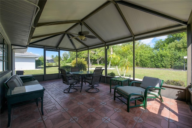 sunroom featuring vaulted ceiling and ceiling fan