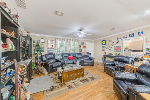 living room featuring ceiling fan, hardwood / wood-style flooring, and crown molding