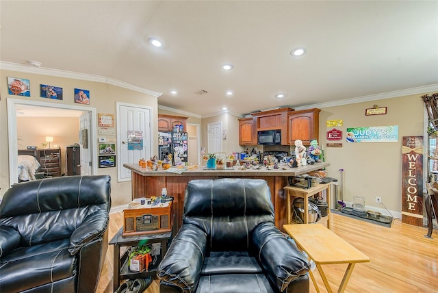 living room featuring ornamental molding and light hardwood / wood-style floors