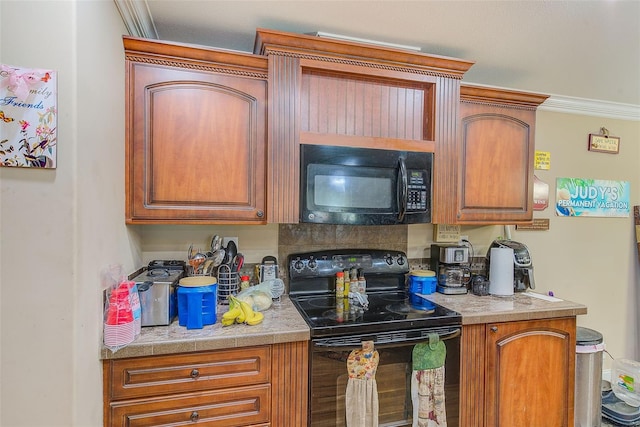 kitchen with black appliances and crown molding