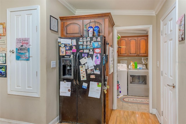 kitchen featuring ornamental molding, light wood-type flooring, washer and clothes dryer, and black refrigerator with ice dispenser