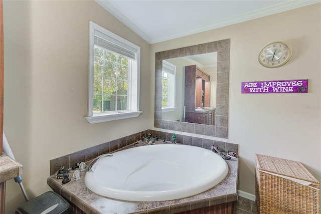 bathroom with ornamental molding and a tub