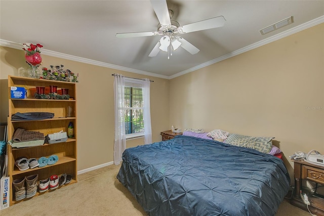 carpeted bedroom with ornamental molding and ceiling fan