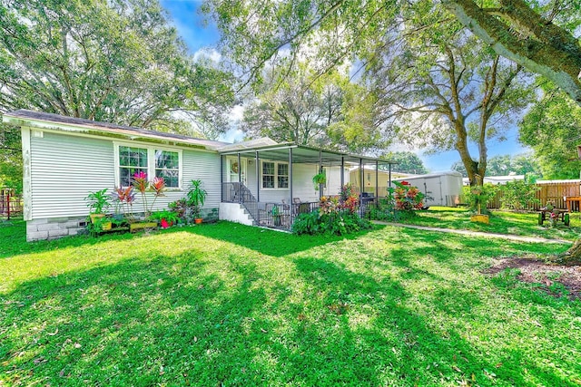 rear view of house with a yard and a porch