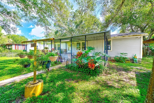 rear view of property with a lawn and covered porch