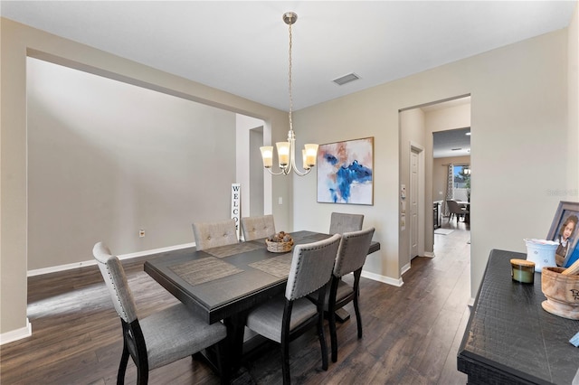 dining area featuring a chandelier and dark wood-type flooring