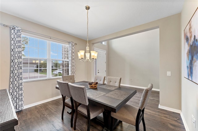 dining space with a notable chandelier and dark hardwood / wood-style floors