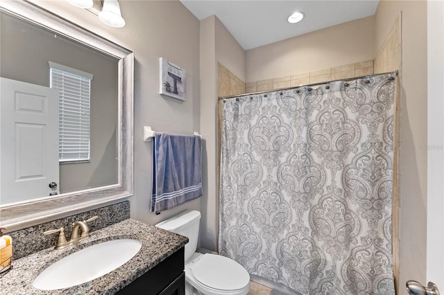 bathroom featuring vanity, toilet, and a shower with curtain