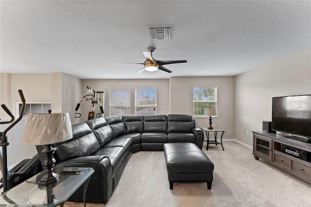 living room with light colored carpet, baseboards, a ceiling fan, and visible vents