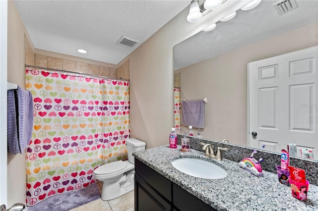 bathroom featuring vanity, a textured ceiling, walk in shower, tile patterned flooring, and toilet