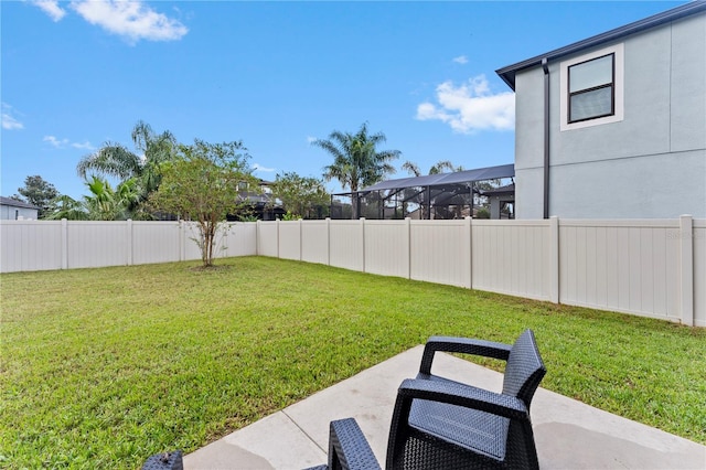 view of yard featuring glass enclosure and a patio area