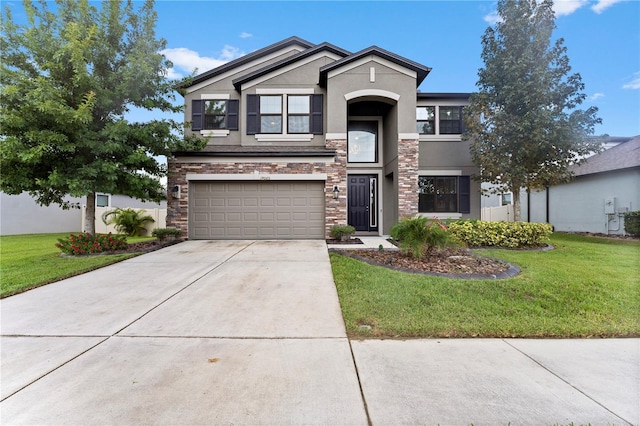 view of front of house with a front yard and a garage