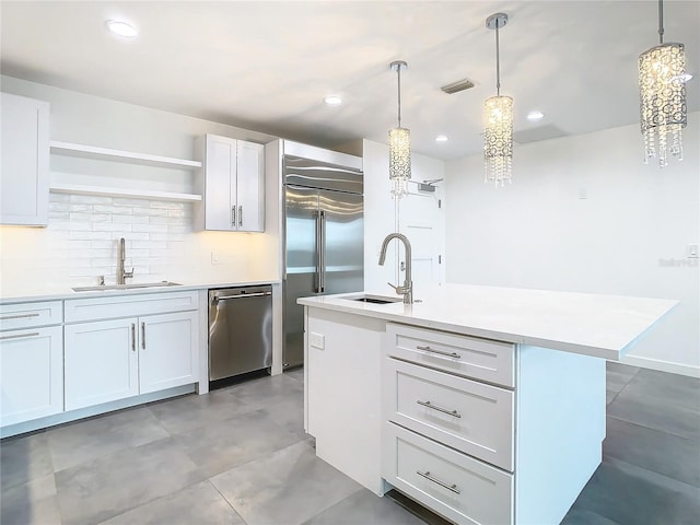 kitchen with white cabinets, appliances with stainless steel finishes, and sink