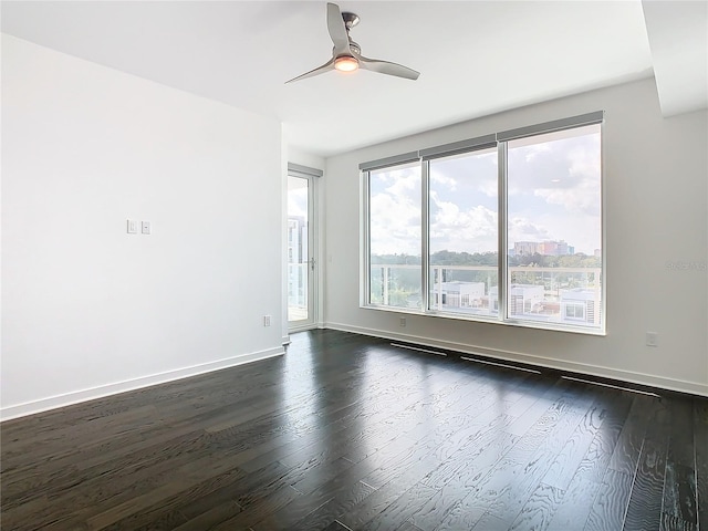 spare room featuring ceiling fan and dark hardwood / wood-style floors