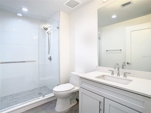 bathroom with toilet, vanity, and walk in shower