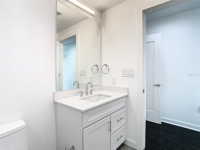 bathroom with toilet and vanity