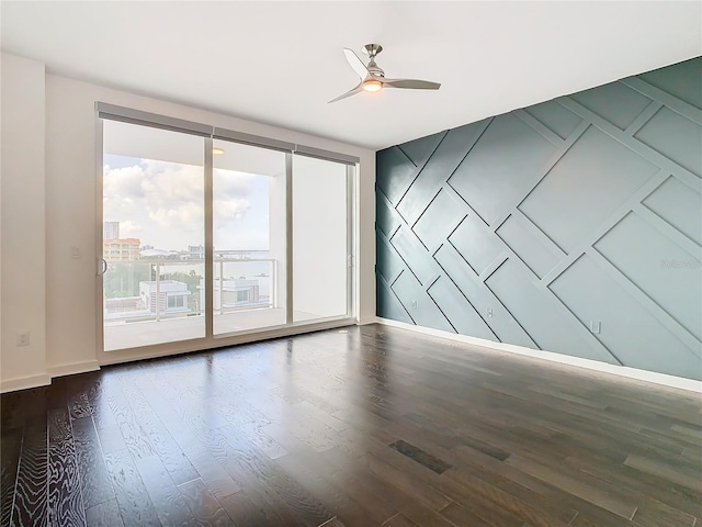 spare room with ceiling fan, wood-type flooring, and plenty of natural light