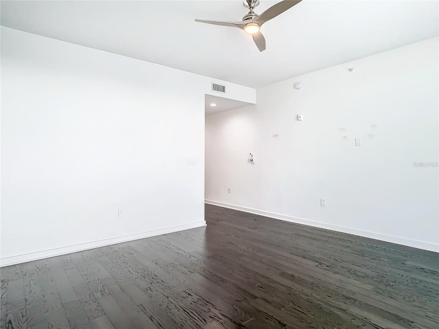 spare room with ceiling fan and dark hardwood / wood-style flooring