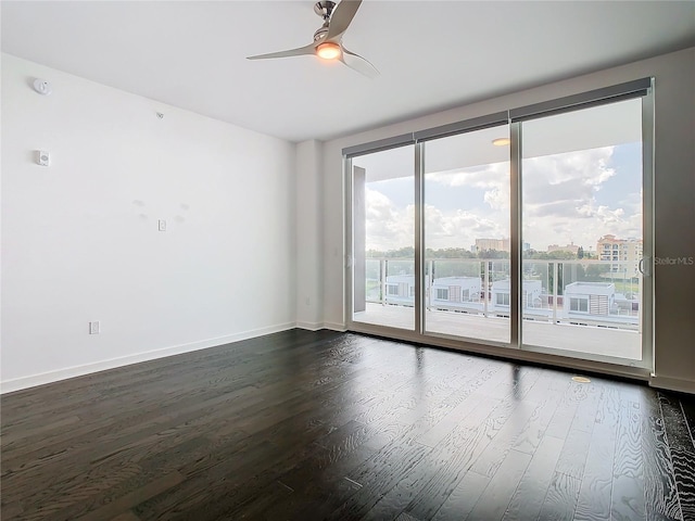 unfurnished room with ceiling fan and dark hardwood / wood-style floors