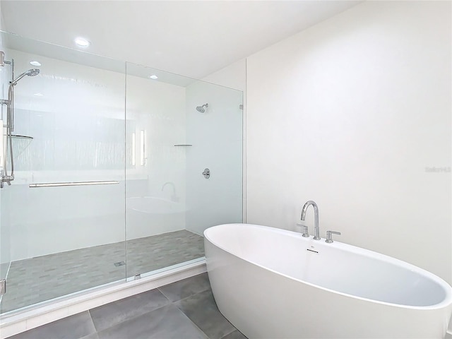 bathroom with tile patterned flooring and independent shower and bath