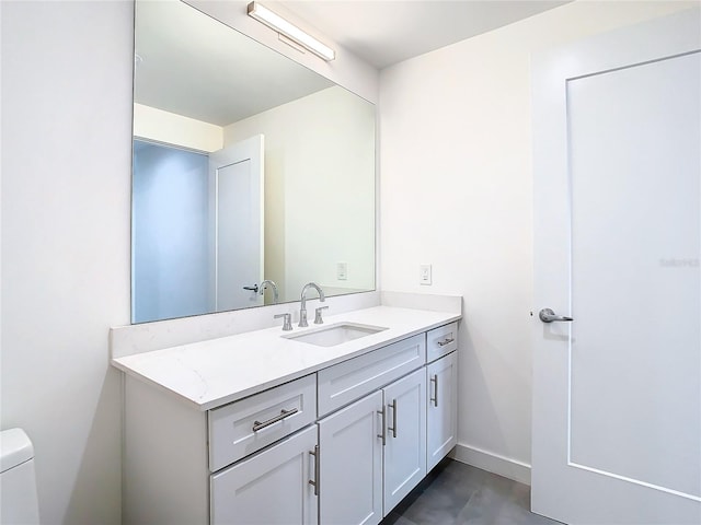 bathroom featuring toilet and vanity