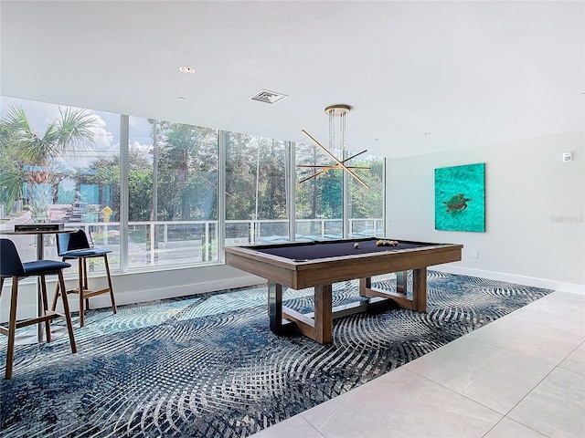 game room with tile patterned floors, pool table, and an inviting chandelier