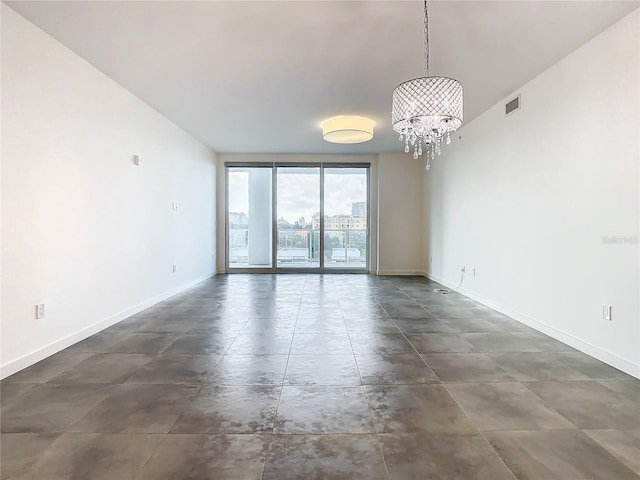 unfurnished room with an inviting chandelier