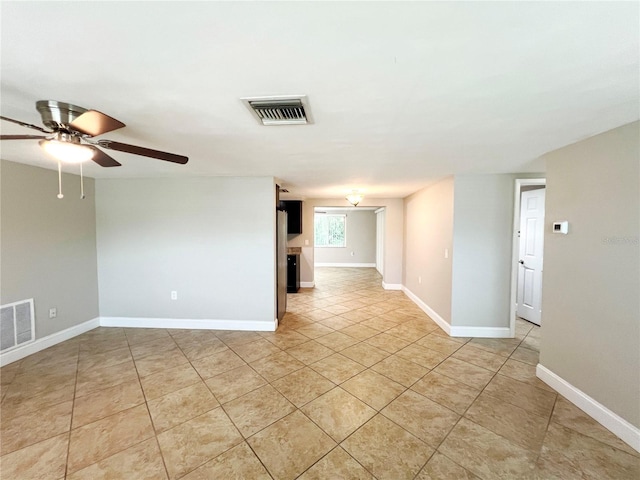 spare room with light tile patterned floors and ceiling fan