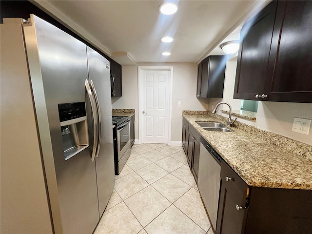 kitchen featuring dark brown cabinets, light tile patterned floors, stainless steel appliances, and sink