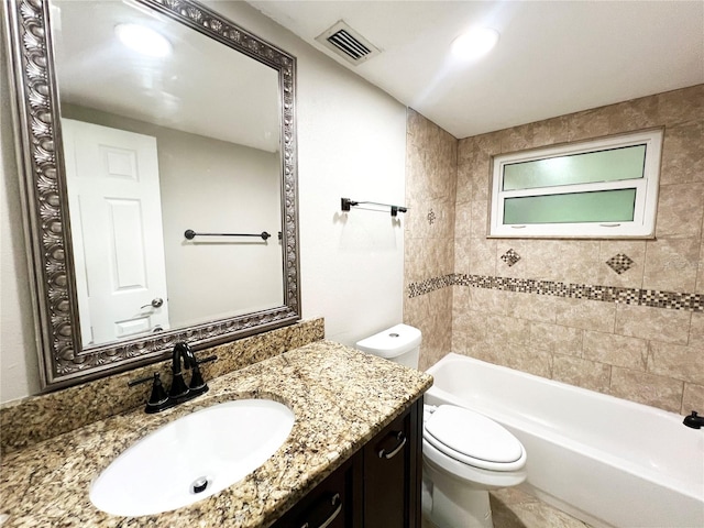 full bathroom with vanity, tiled shower / bath combo, and toilet