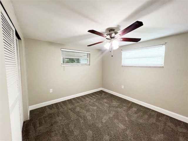 unfurnished bedroom featuring ceiling fan and dark colored carpet