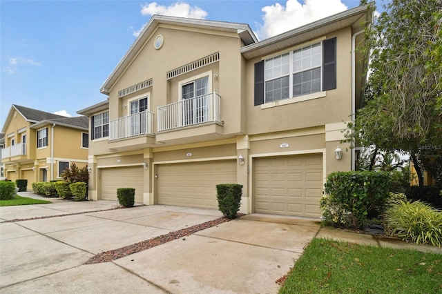 multi unit property featuring a balcony and a garage