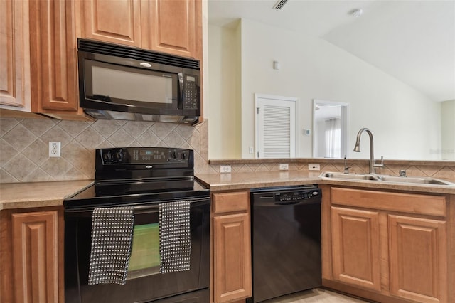 kitchen with lofted ceiling, black appliances, backsplash, and sink