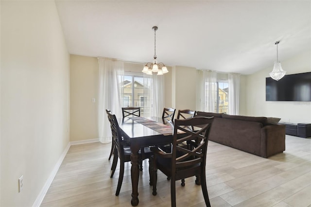 dining area featuring a chandelier and light hardwood / wood-style floors