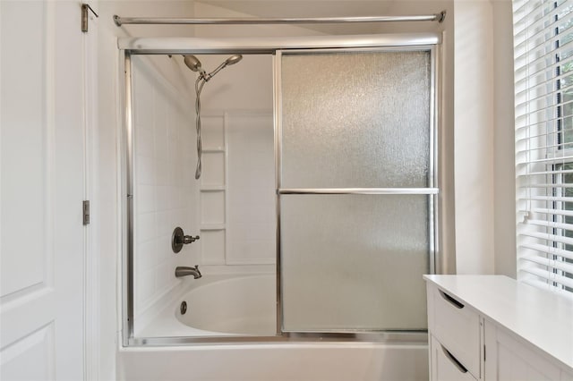 bathroom featuring vanity and enclosed tub / shower combo