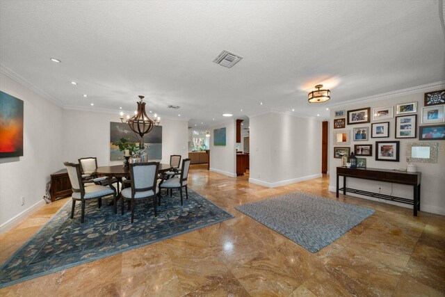 dining space featuring ornamental molding, a textured ceiling, and a notable chandelier