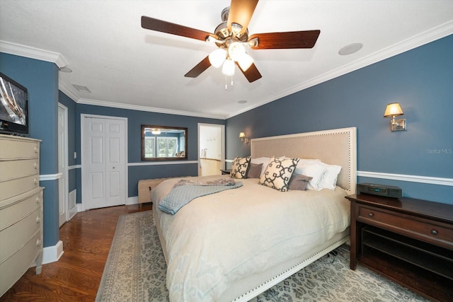 bedroom featuring dark wood-type flooring, ceiling fan, and ornamental molding