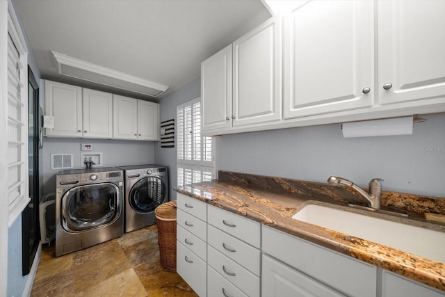 laundry area featuring cabinets, washer and clothes dryer, crown molding, and sink