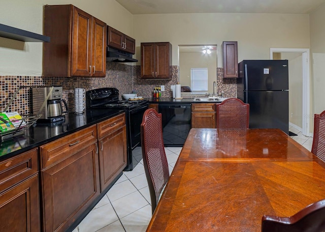 kitchen featuring light tile patterned floors, backsplash, sink, and black appliances