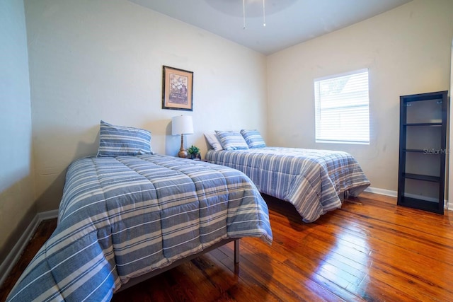 bedroom with dark hardwood / wood-style floors