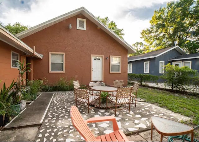 back of property featuring a patio area