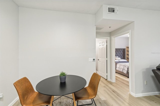 dining area with light hardwood / wood-style floors