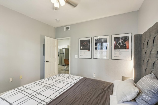 bedroom with ceiling fan and stainless steel refrigerator