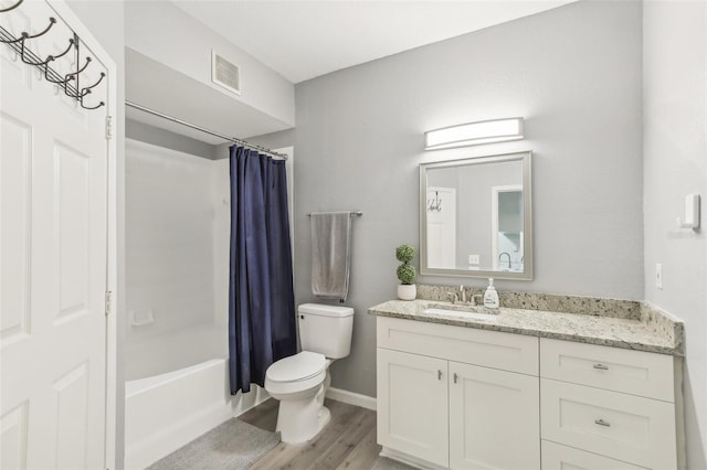 full bathroom featuring wood-type flooring, vanity, toilet, and shower / bath combo