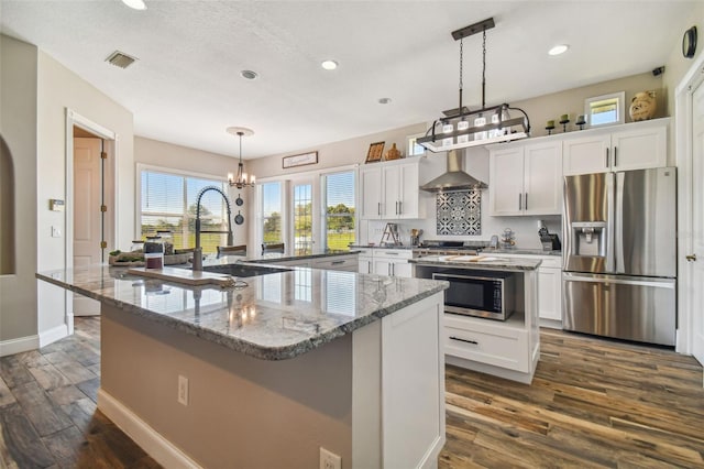 kitchen featuring appliances with stainless steel finishes, a kitchen island, and white cabinets