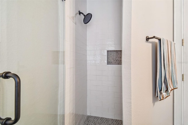 bathroom with a shower with door